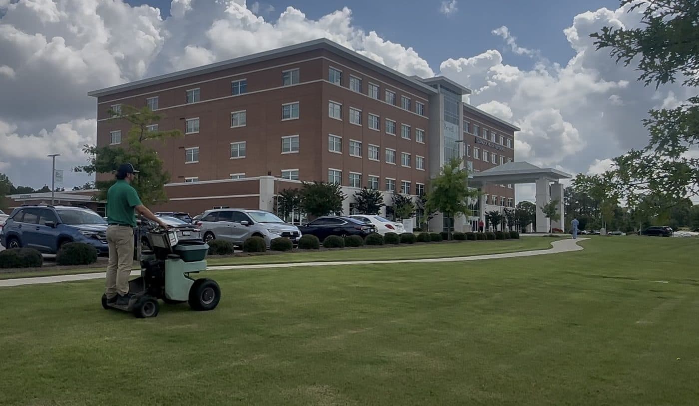 GLS Turf technician applying a granular soil amendment on a commercial property in Columbia, South Carolina