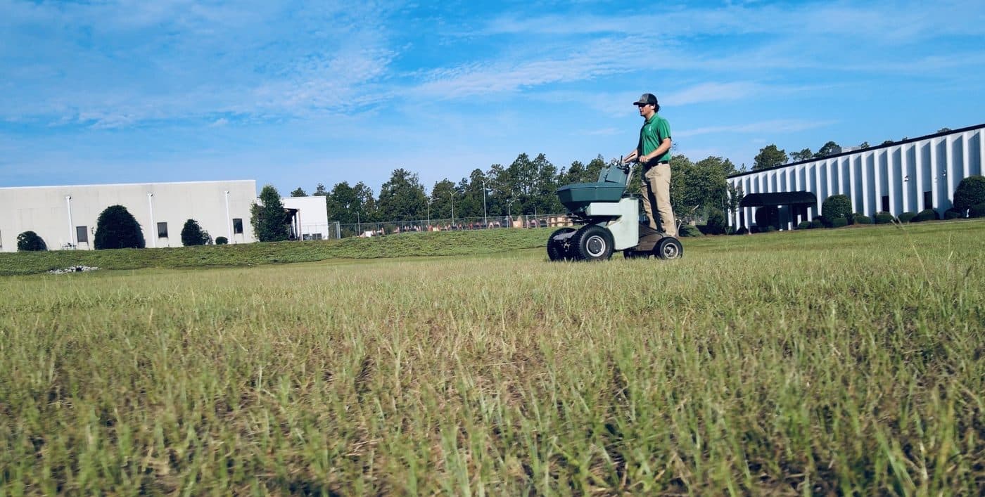 GLS Turf technician broadcasting an insect treatment across turf in Lexington, South Carolina