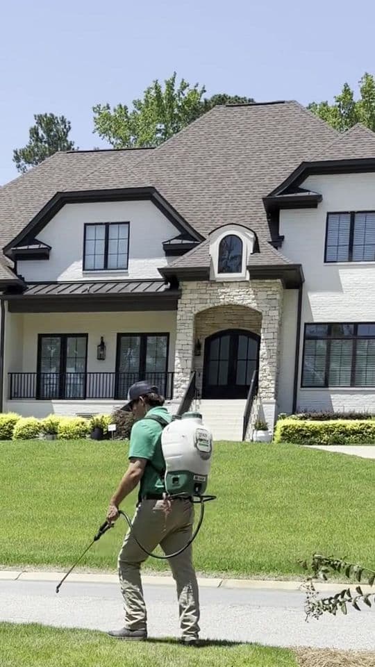 GLS Turf technician applying weed control at a Lexington home